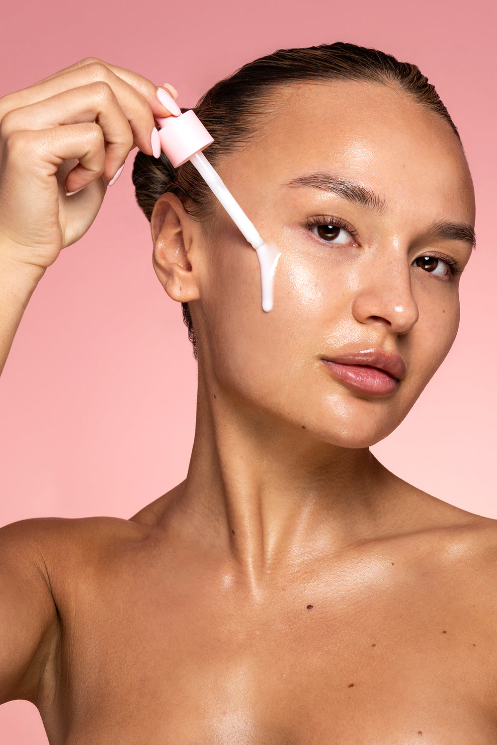 P.Louise Vitamin E & Probiotic Glow Serum on a model