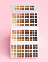 An XXXL Wedding Wish eyeshadow Palette by P.Louise that is open showing all the shades against a pink background