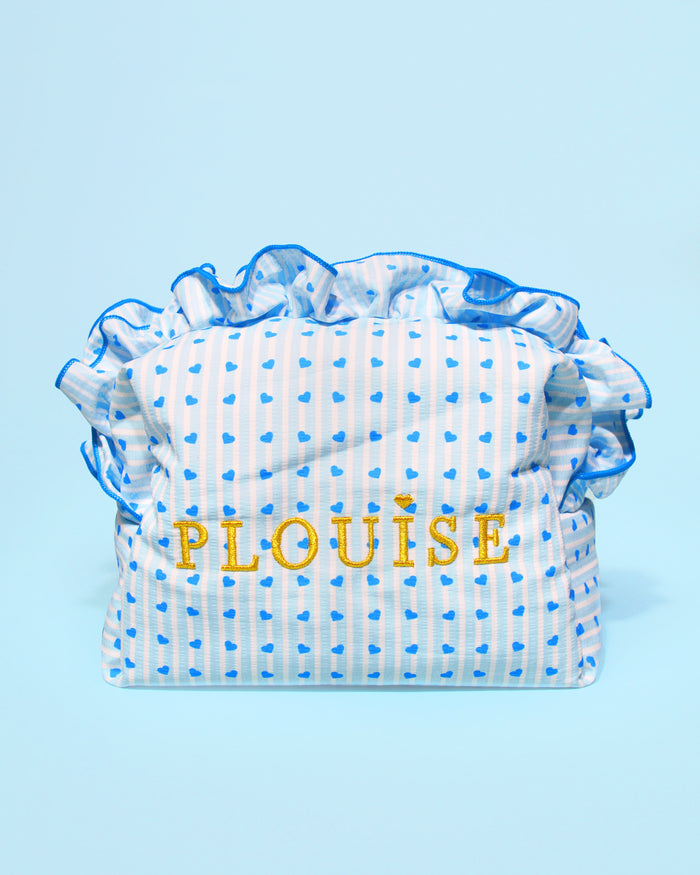 Large blue and white striped P.Louise blue raspberry travel beauty, makeup and skincare bag with frills and a blue raspberry design