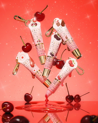 Pink cherry scented protect your pout lip conditioner tubes with cherry design on a red background