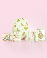 Green P.Louise Easter Egg in Chocolate Strawberry scent with green makeup skincare and beauty products in front