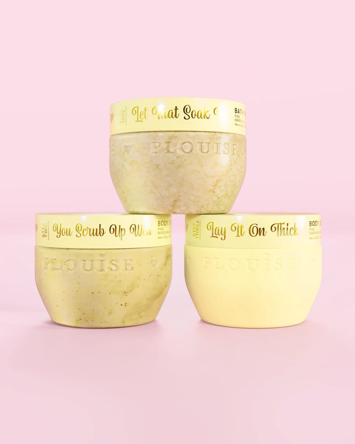 Three P.Louise Hop Into Self-Care Starwberry Shortcake yellow containers featuring bath salts, body scrub and body butter with gold text on a pink background