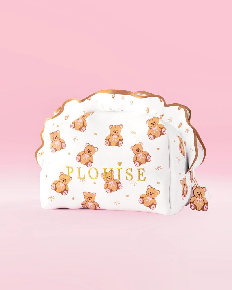 A P.Louise large teddy bear print skincare and makeup bag with a frill design against a pink background