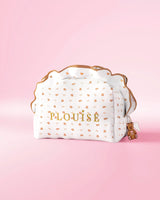 A P.Louise frilled skincare and makeup bag with a small print teddy bear design against a pink background
