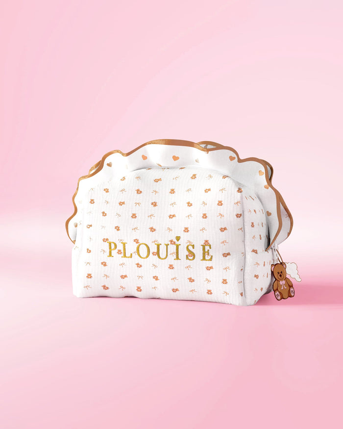 A P.Louise frilled skincare and makeup bag with a small print teddy bear design against a pink background