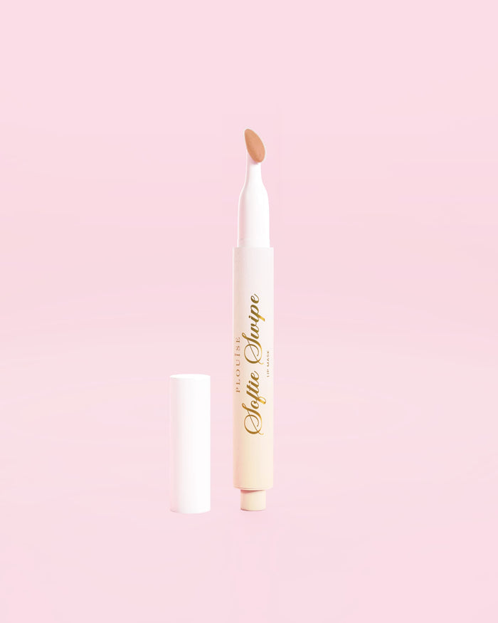 An image showing the P.Louise Softie Swipe Tinted Lip Mask in Barely There shade against a pink background