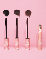 3 P.Louise Tearproof waterproof mascara wands with their color swatch next to each one and the pink product tube on the end against a pink background
