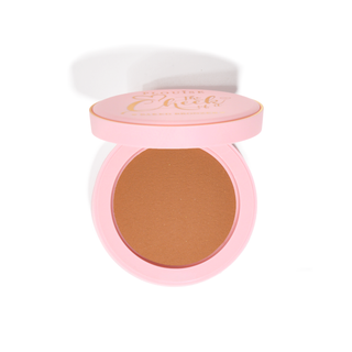 A compact baked bronzer with a pink lid, showing a light to medium shade with a neutral undertone.