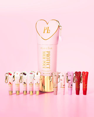 Set of pink and red cherry scented lip conditioners with a prominent pink and gold portect your pout bottle in the center on a pink background.
