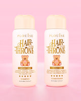 Two bottles of P.Louise Hair to the Throne Coconut Cake shampoo and conditioner on a pink background