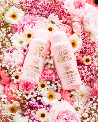 P.Louise Signature Scent Shampoo & Conditioner Set surrounded by flowers