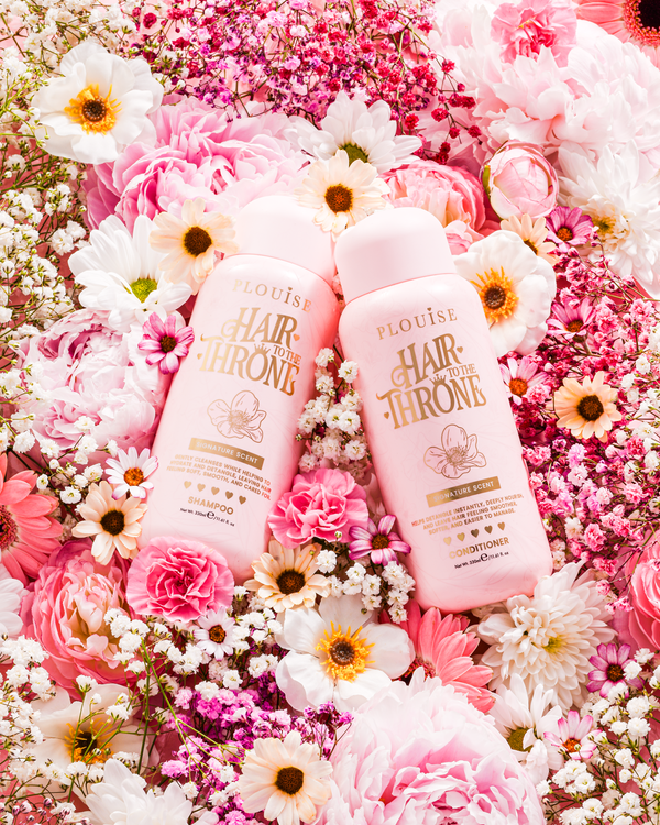 P.Louise Signature Scent Shampoo & Conditioner Set surrounded by flowers