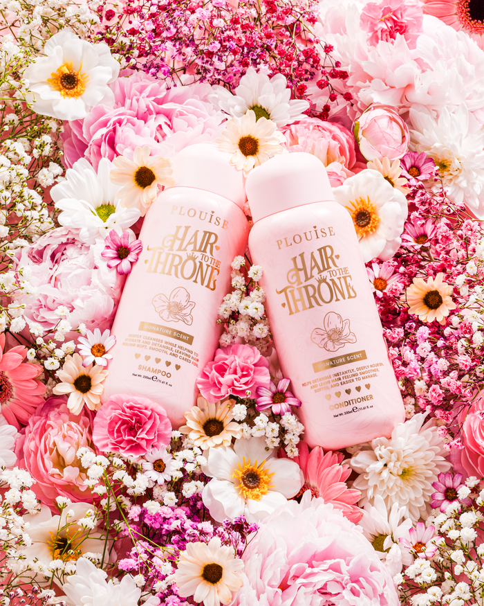 P.Louise Signature Scent Shampoo & Conditioner Set surrounded by flowers