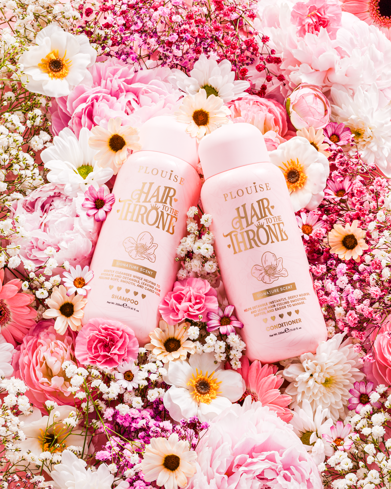 P.Louise Signature Scent Shampoo & Conditioner Set surrounded by flowers