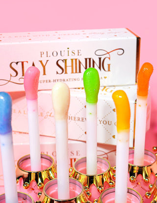 Several P.Louise STay Shining Lip Oil applicator tips with various lip oils colors shown