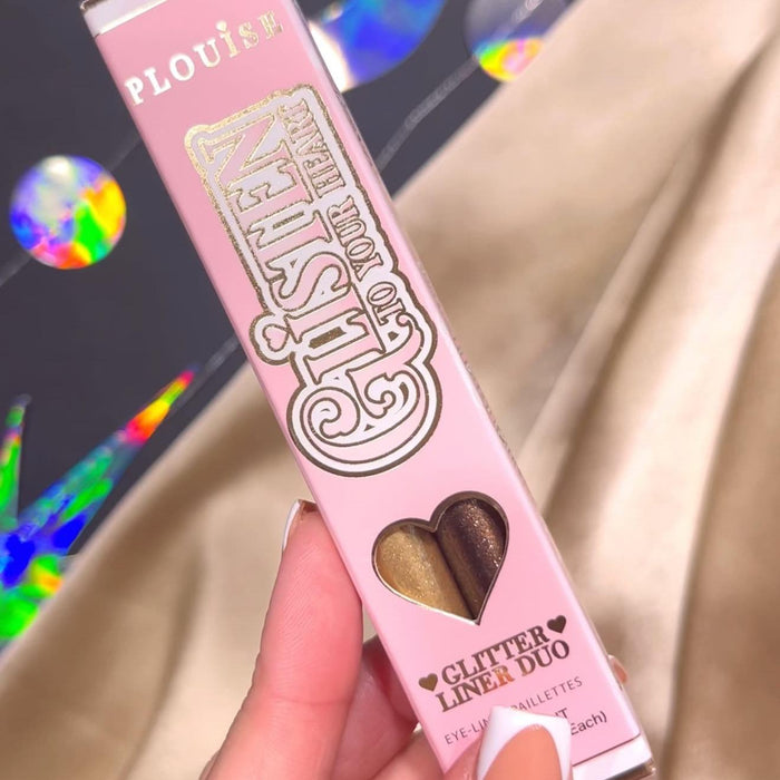 Pink P.Louise Glisten To Your Heart Liquid Glitter Eyeliner Set in Dusk Diva  packaging held by a hand with white nail polish.